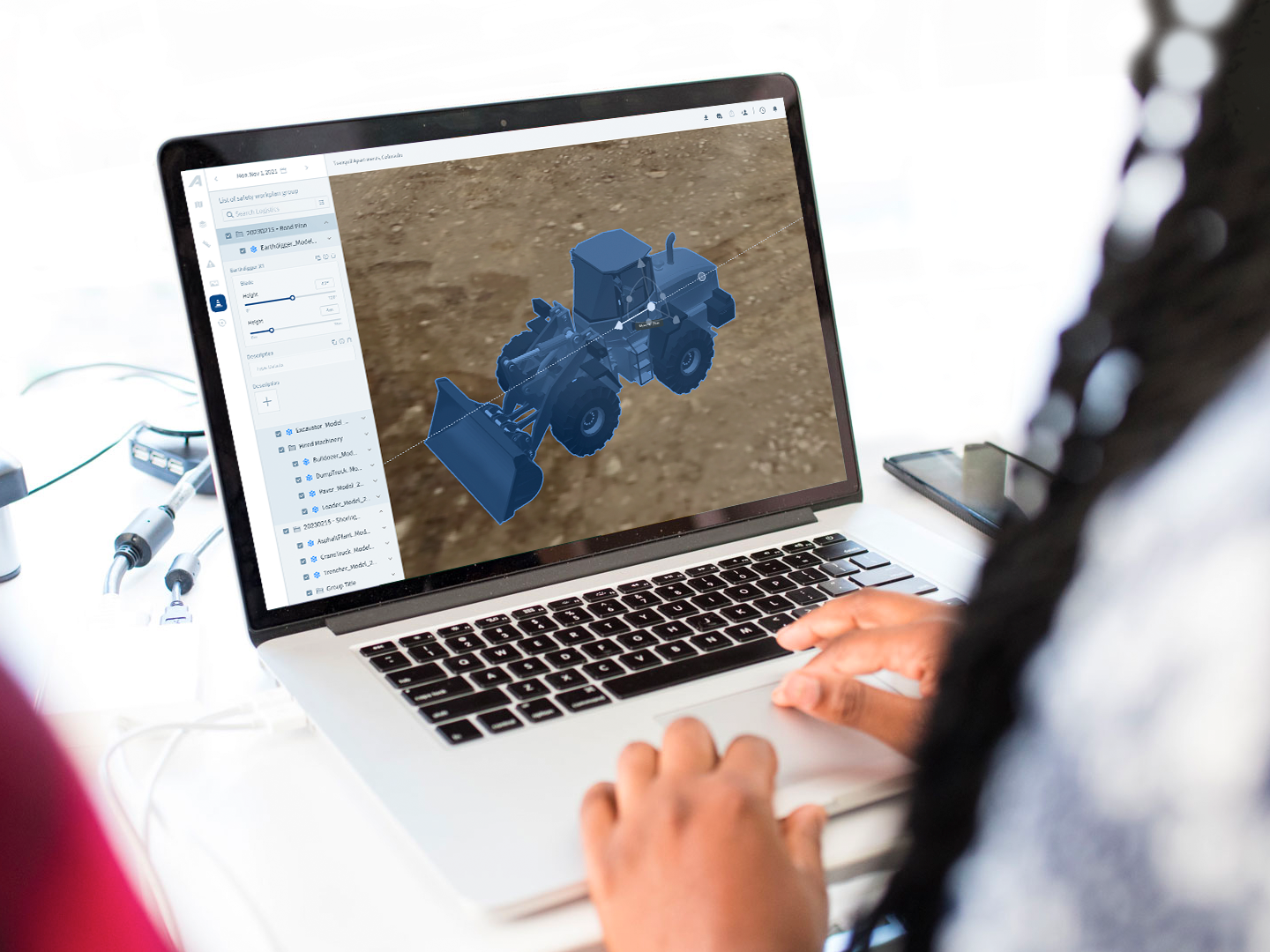 A 3D excavator model in the platform on a laptop