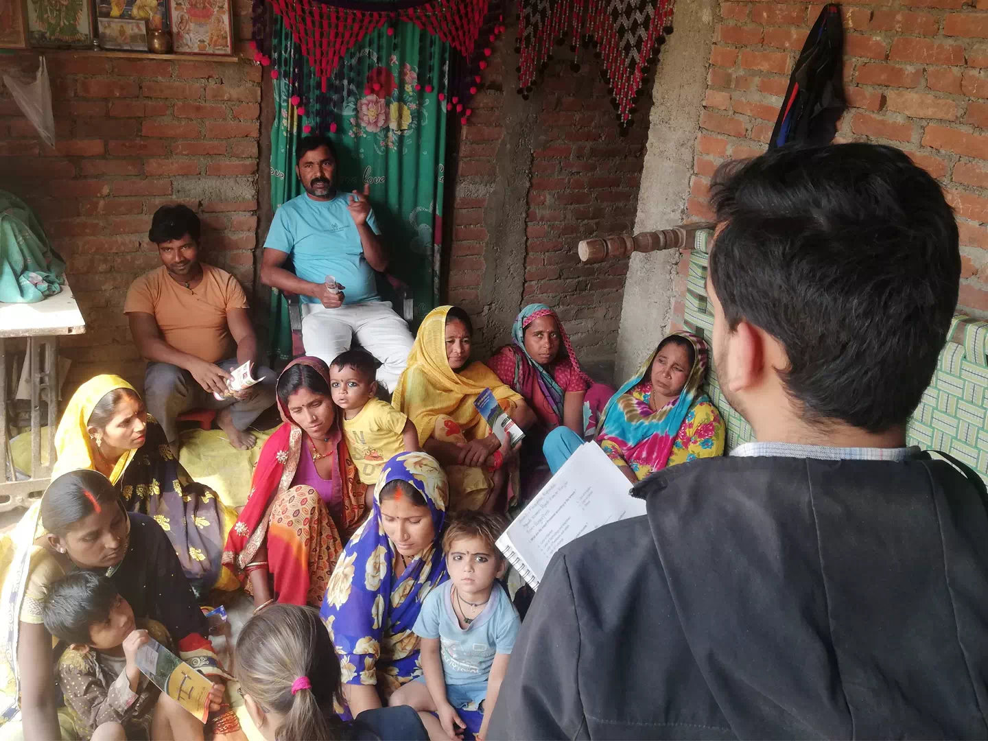 An agri-expert talking with a group of farmers