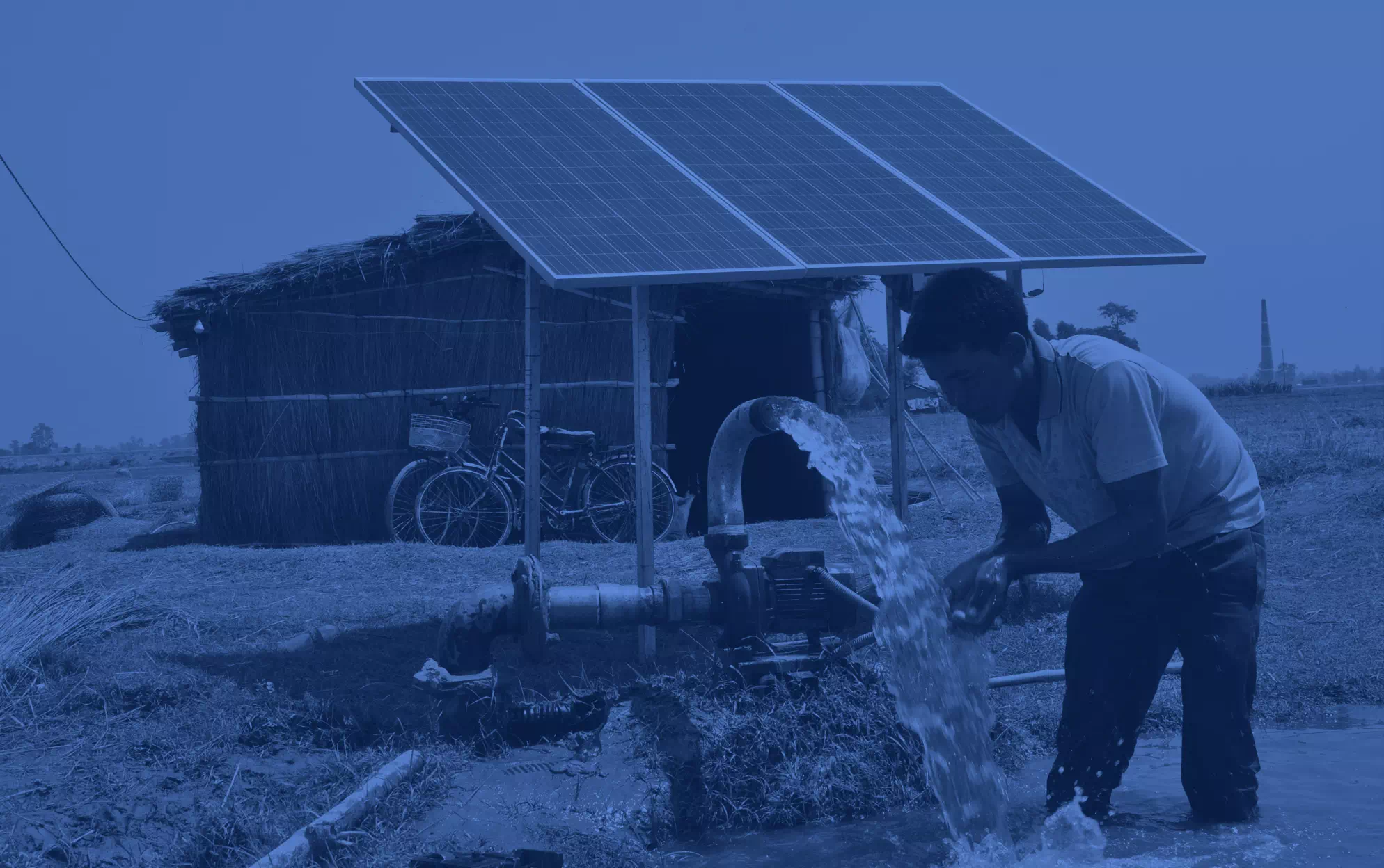 An image of a nepalese farmer using a solar powered water pump